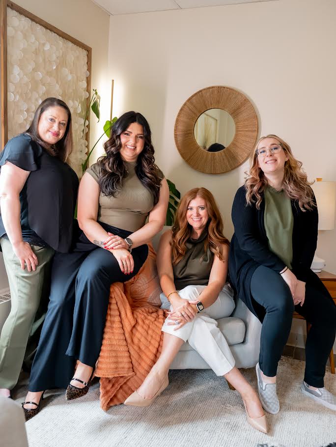 Loriann Fetter team in warm lounge setting